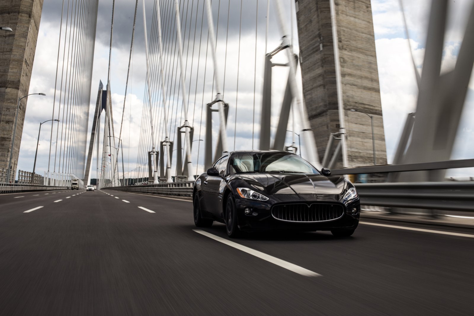 Technician carefully detailing a premium vehicle in the studio